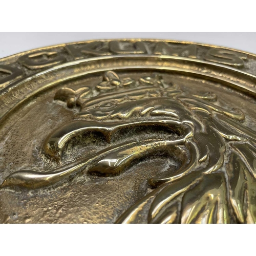 359 - A Swedish brass ship builder's plaque, inscribed Kockums Malmo 1891, diameter 29.5cm.