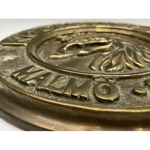 359 - A Swedish brass ship builder's plaque, inscribed Kockums Malmo 1891, diameter 29.5cm.