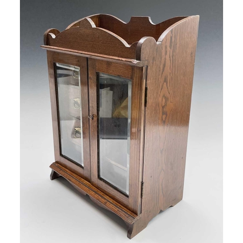 362 - An Edwardian oak two door smoker's cabinet with fitted interior, with key. Height 46.5cm, width 32.5... 