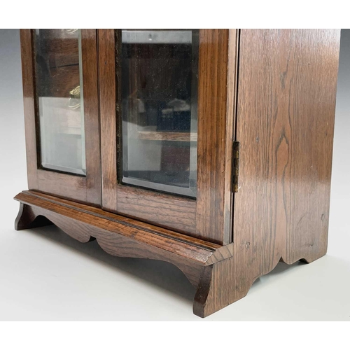 362 - An Edwardian oak two door smoker's cabinet with fitted interior, with key. Height 46.5cm, width 32.5... 