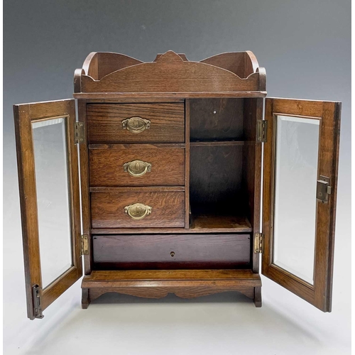 362 - An Edwardian oak two door smoker's cabinet with fitted interior, with key. Height 46.5cm, width 32.5... 