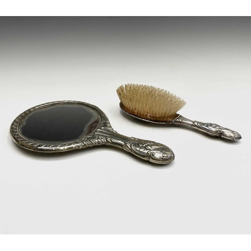 363 - A hallmarked silver-backed hairbrush and a silver-plated hand mirror, both decorated with the 'Reyno... 