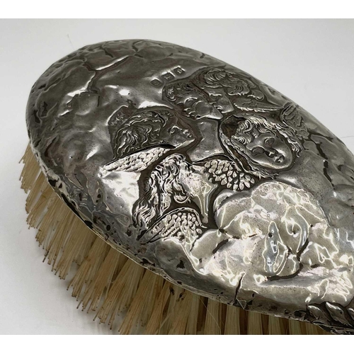 363 - A hallmarked silver-backed hairbrush and a silver-plated hand mirror, both decorated with the 'Reyno... 