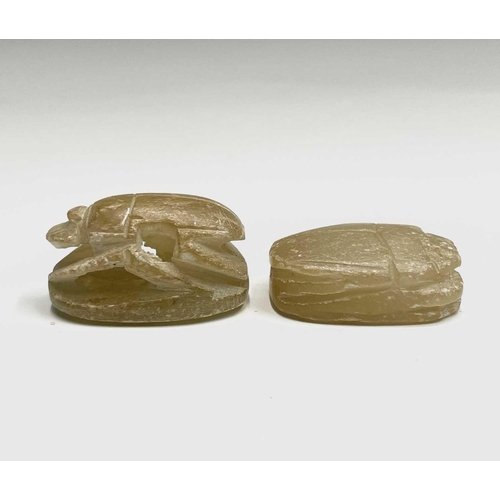 366 - An elaborately carved African nut, height 11.5cm, together with two carved alabaster scarab beetles,... 