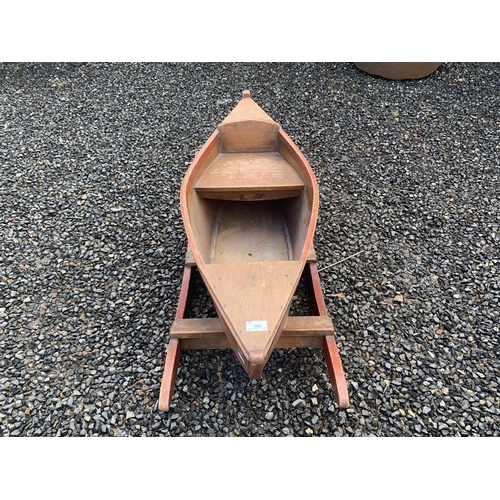 380 - A child's vintage painted wooden toy rocking boat, length 99cm.