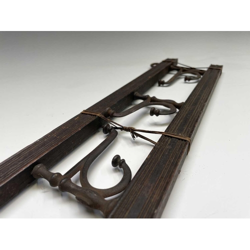 383 - An Edwardian reeded oak coat rack, fitted with four folding steel hooks, width 55cm, together with a... 