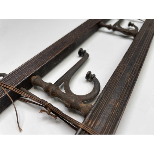 383 - An Edwardian reeded oak coat rack, fitted with four folding steel hooks, width 55cm, together with a... 