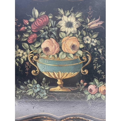 384 - A 19th century papier-mache tray, painted with a flower filled urn, 60X77cm.