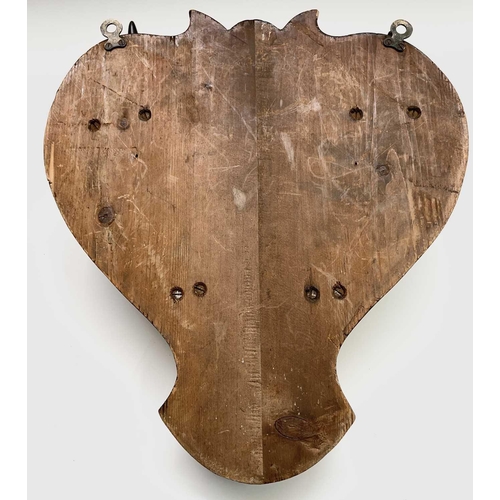 391 - A shield-shaped walnut and cow horn coat rack. Height 48cm overall.