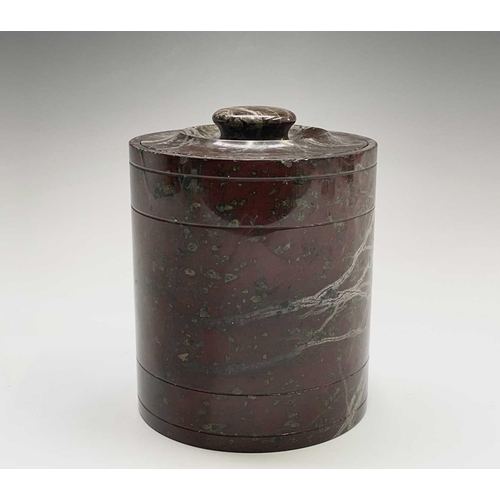 394 - A Cornish serpentine tobacco jar of cylindrical form. Height 14cm.