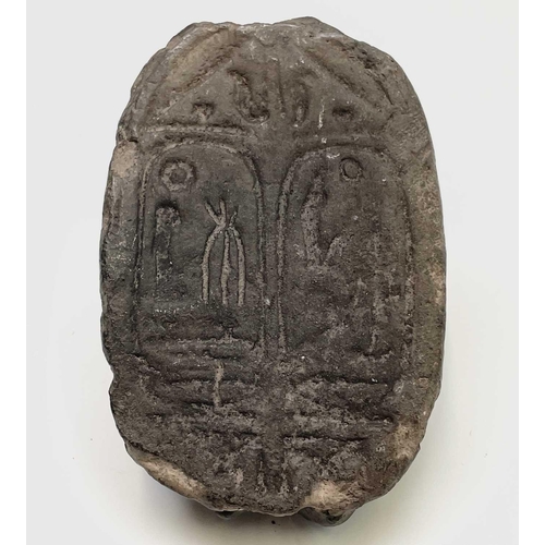 395 - An Egyptian carved stone sphinx headed scarab seal. Length 7.5cm.