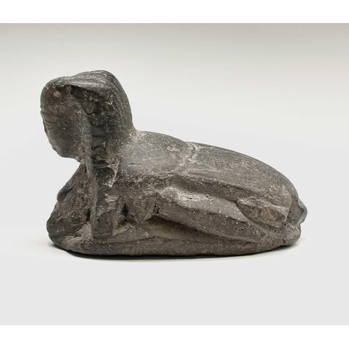 395 - An Egyptian carved stone sphinx headed scarab seal. Length 7.5cm.