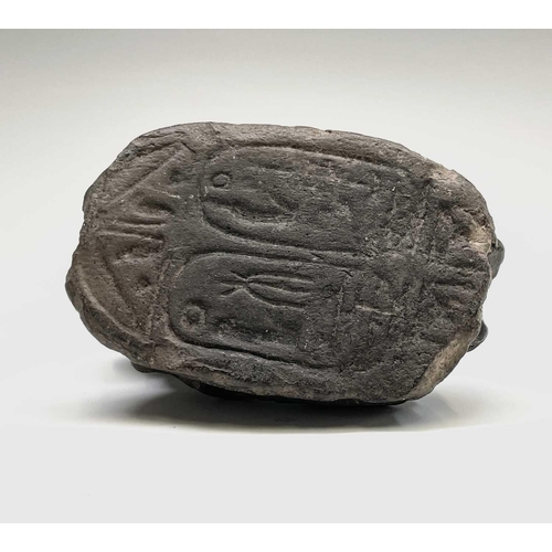 395 - An Egyptian carved stone sphinx headed scarab seal. Length 7.5cm.