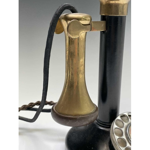 41 - A brass, painted metal and bakelite candlestick telephone, stamped PX150, height 33cm.