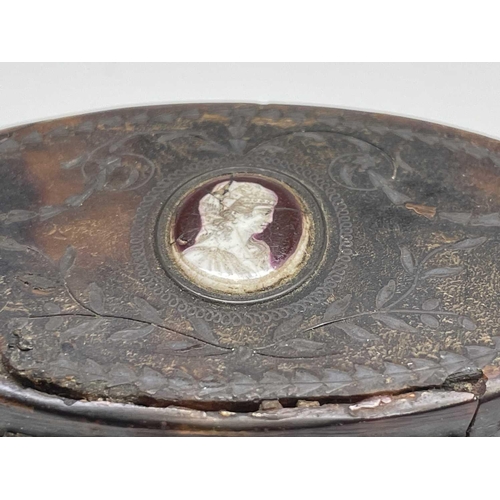 412 - A 19th century tortoiseshell and pique snuff box, with oval enamel inset portrait medallion, width 7... 