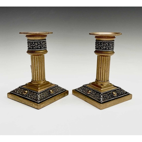 416 - A pair of late 19th/early 20th century Walker & Hall Celtic Revival gilt bronze candlesticks, having... 