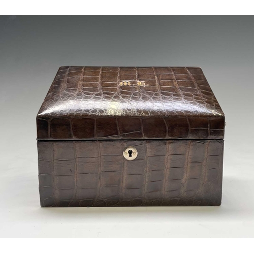 417 - An Asprey crocodile hide covered stationery box with green silk fitted interior. Maximum height 17cm... 