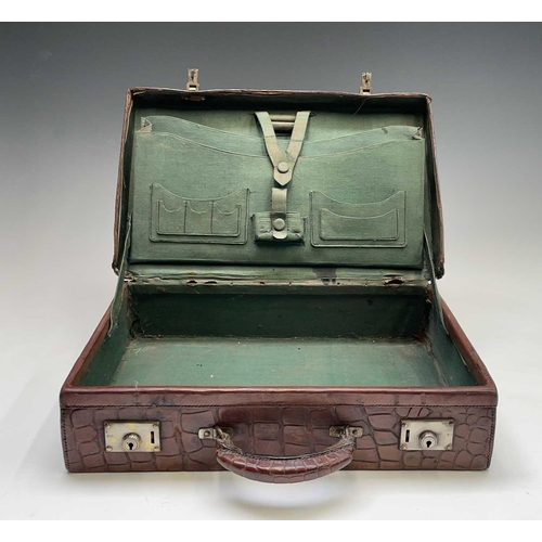 419 - An early 20th century crocodile skin briefcase with fitted interior, the silver plated lock plates m... 