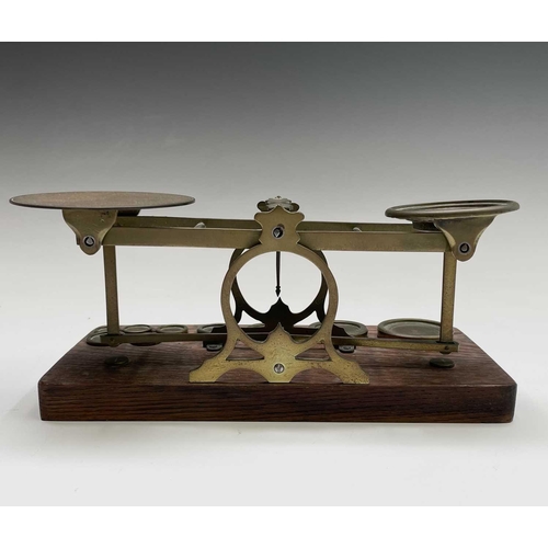 42 - A set of late Victorian Sampson Mordan & Co brass and oak postal scales, the base set with nine bras... 