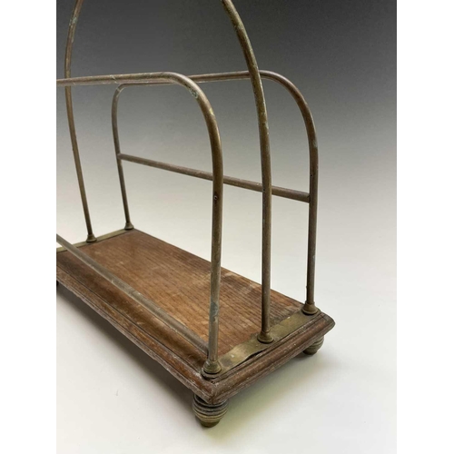 421 - An Edwardian brass and ash magazine rack, width 35.5cm, together with a folding spark guard (2).