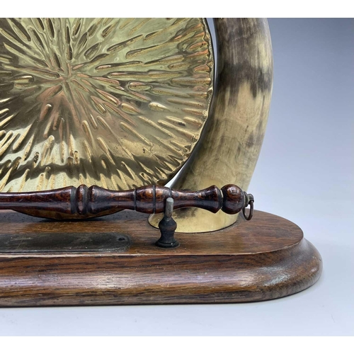 424 - An Edwardian horn mounted oak and brass gong, height 31cm, together with a model cannon on ebonised ... 