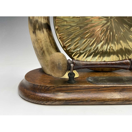 424 - An Edwardian horn mounted oak and brass gong, height 31cm, together with a model cannon on ebonised ... 