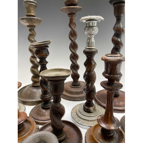 426 - A pair of oak twist candlesticks, 1920s, with metal sconces, height 20.5cm, together with other cand... 