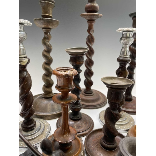 426 - A pair of oak twist candlesticks, 1920s, with metal sconces, height 20.5cm, together with other cand... 