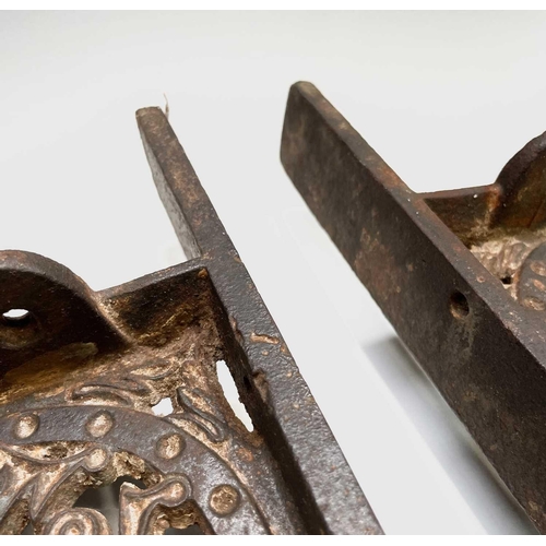 436 - A pair of cast iron aesthetic period wall brackets, with the initials T & W F, width 49.5cm.