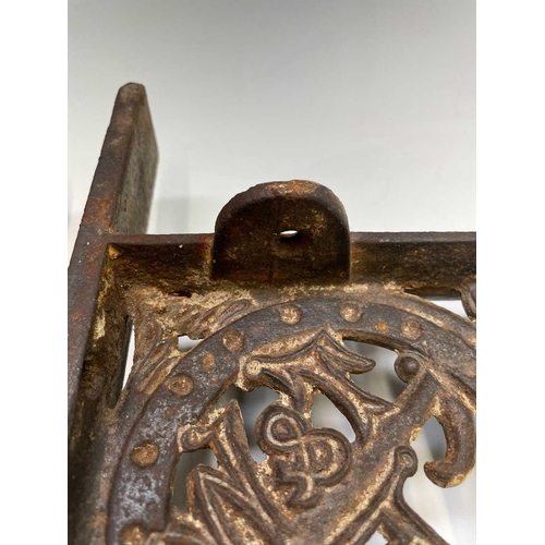 436 - A pair of cast iron aesthetic period wall brackets, with the initials T & W F, width 49.5cm.