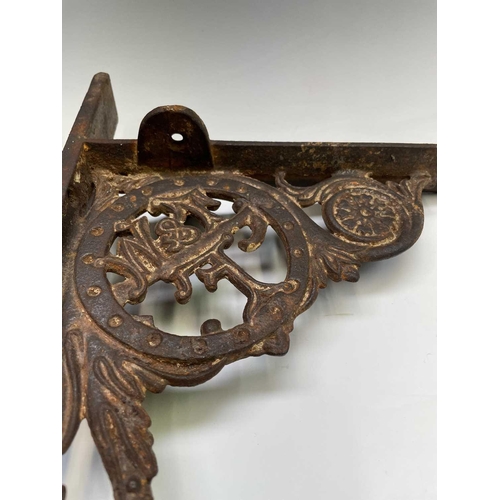 436 - A pair of cast iron aesthetic period wall brackets, with the initials T & W F, width 49.5cm.