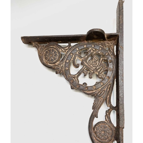 436 - A pair of cast iron aesthetic period wall brackets, with the initials T & W F, width 49.5cm.