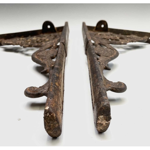 436 - A pair of cast iron aesthetic period wall brackets, with the initials T & W F, width 49.5cm.