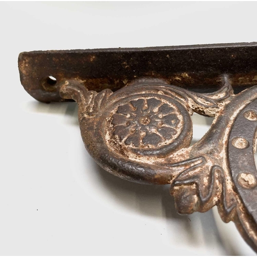 436 - A pair of cast iron aesthetic period wall brackets, with the initials T & W F, width 49.5cm.