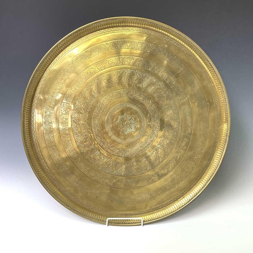 449 - An Indian circular brass tray, engraved with bands of animals and birds, diameter 58cm, together wit... 