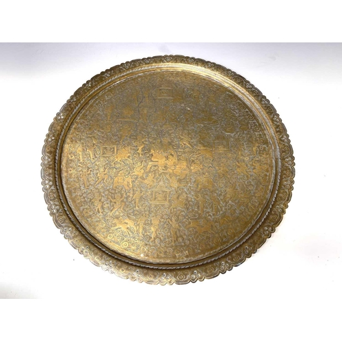 449 - An Indian circular brass tray, engraved with bands of animals and birds, diameter 58cm, together wit... 