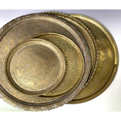 449 - An Indian circular brass tray, engraved with bands of animals and birds, diameter 58cm, together wit... 