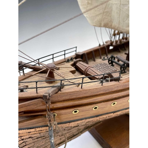 45 - A wooden model of the clipper Cutty Sark, with copper clad hull, titled and mounted on a rectangular... 