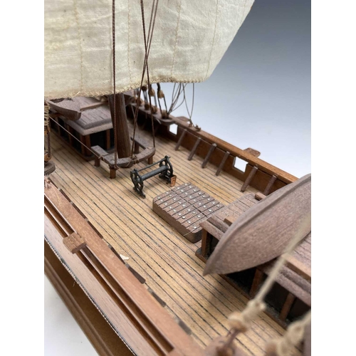 45 - A wooden model of the clipper Cutty Sark, with copper clad hull, titled and mounted on a rectangular... 