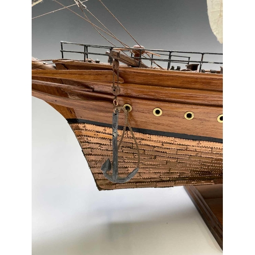 45 - A wooden model of the clipper Cutty Sark, with copper clad hull, titled and mounted on a rectangular... 