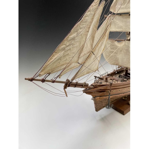 45 - A wooden model of the clipper Cutty Sark, with copper clad hull, titled and mounted on a rectangular... 