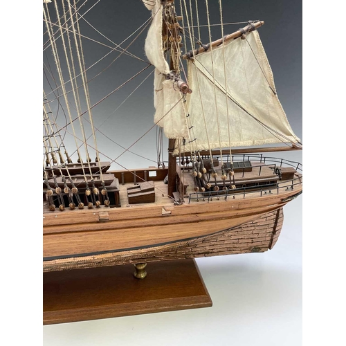 45 - A wooden model of the clipper Cutty Sark, with copper clad hull, titled and mounted on a rectangular... 