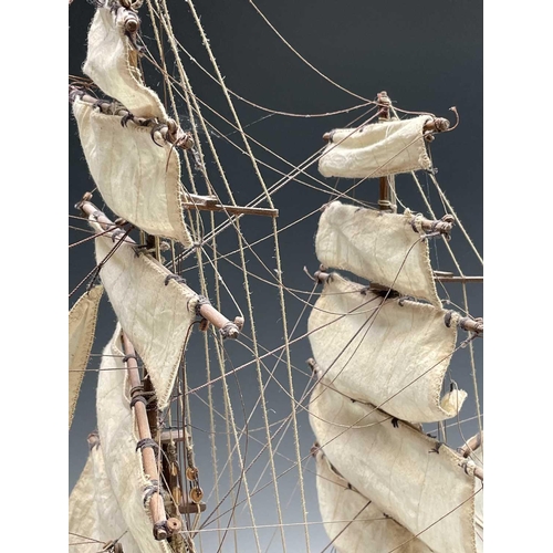 45 - A wooden model of the clipper Cutty Sark, with copper clad hull, titled and mounted on a rectangular... 