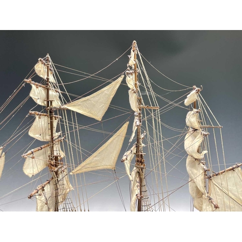 45 - A wooden model of the clipper Cutty Sark, with copper clad hull, titled and mounted on a rectangular... 