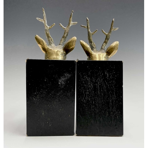 457 - A pair of brass bookends, 1920s, mounted with cast brass stags heads, height 25.5cm.