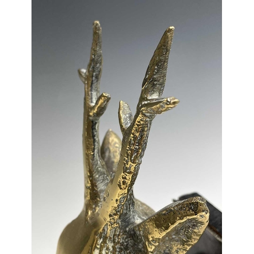 457 - A pair of brass bookends, 1920s, mounted with cast brass stags heads, height 25.5cm.