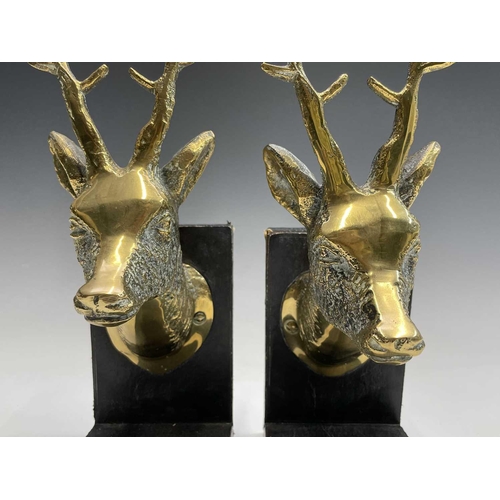 457 - A pair of brass bookends, 1920s, mounted with cast brass stags heads, height 25.5cm.