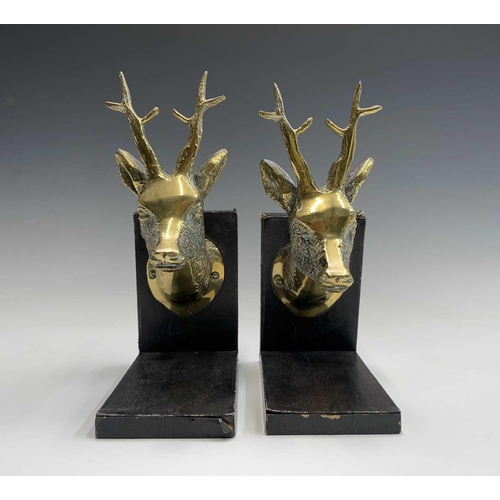 457 - A pair of brass bookends, 1920s, mounted with cast brass stags heads, height 25.5cm.