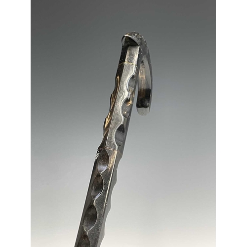 458 - A carved horn sectional walking stick, early 20th century, height 91cm.