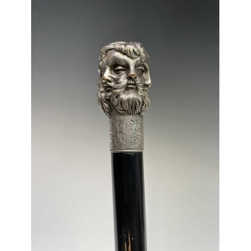 465 - An ebonised walking cane surmounted by an Elkington five headed Greek God mask, length.91 cm.